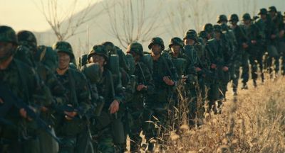 Still from Past Lives (2023) that has been tagged with: wide shot & group-shot & military & day