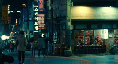 Still from Past Lives (2023) that has been tagged with: exterior & night & wide shot & city