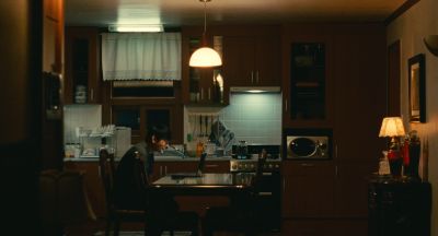 Still from Past Lives (2023) that has been tagged with: practical lamp & interior & laptop & night