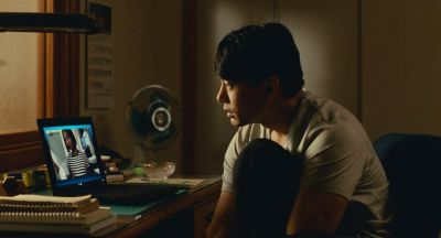 Still from Past Lives (2023) that has been tagged with: night & interior & desk & clean single