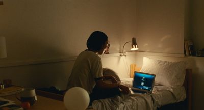 Still from Past Lives (2023) that has been tagged with: interior & night & bed & practical lamp