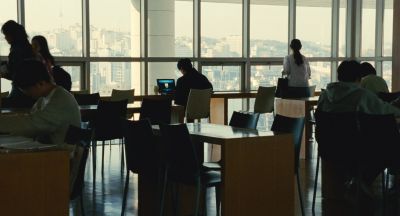 Still from Past Lives (2023) that has been tagged with: wide shot & interior & day & working