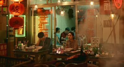 Still from Past Lives (2023) that has been tagged with: night & interior & wide shot & restaurant