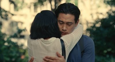 Still from Past Lives (2023) that has been tagged with: hug & two-shot & day & exterior