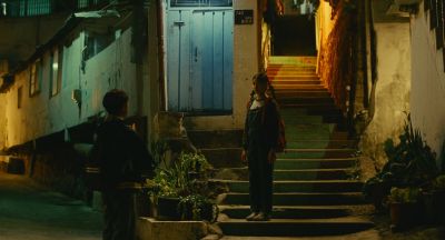 Still from Past Lives (2023) that has been tagged with: wide shot & exterior & stairs & night