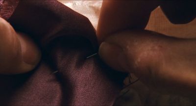 Still from Phantom Thread (2017) that has been tagged with: extreme close-up & historical & period & insert & sewing & day