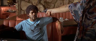 Still from Pulp Fiction (1994) that has been tagged with: interior & gun & diner & over-the-shoulder & medium wide