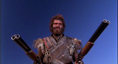Still from Raising Arizona (1987) that has been tagged with: ab4f53 & exterior & day & gun & low-angle