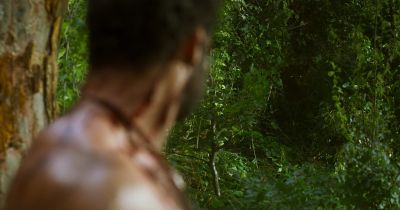 Still from RRR (2022) that has been tagged with: 714f38 & exterior & jungle & day