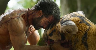 Still from RRR (2022) that has been tagged with: 714f38 & profile shot & tiger