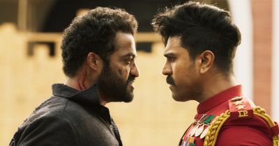 Still from RRR (2022) that has been tagged with: e6be89 & two-shot & arguing & medium close-up & day