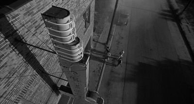 Still from Rumble Fish (1983) that has been tagged with: exterior & black and white & wide shot & movie theater