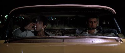 Still from Scarface (1983) that has been tagged with: night & car & medium shot & smoking & interior