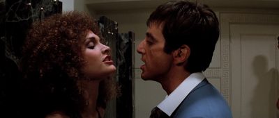 Still from Scarface (1983) that has been tagged with: interior & two-shot & profile shot & night & medium close-up