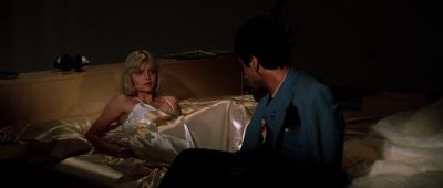 Still from Scarface (1983) that has been tagged with: night & over-the-shoulder & bed & medium wide