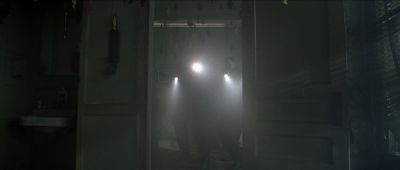 Still from Se7en (1995) that has been tagged with: doorway & haze & flashlight