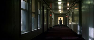 Still from Se7en (1995) that has been tagged with: hallway & one-point-perspective & day & interior & clean single & wide shot