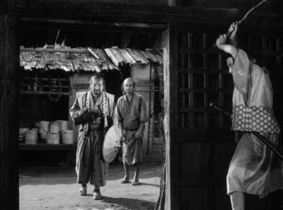 Still from Seven Samurai (1954) that has been tagged with: three-shot & interior & doorway & day & black and white & medium wide