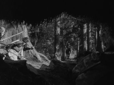 Still from Seven Samurai (1954) that has been tagged with: over-the-shoulder & black and white & three-shot & ambush & day