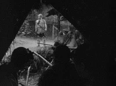 Still from Seven Samurai (1954) that has been tagged with: three-shot & rain & exterior & wide shot
