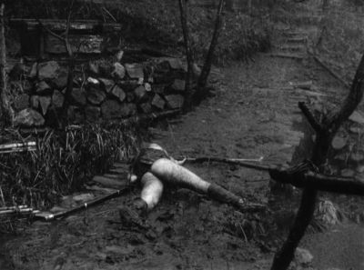Still from Seven Samurai (1954) that has been tagged with: mud & over-the-shoulder & black and white & exterior