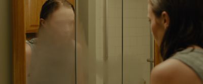Still from Sicario (2015) that has been tagged with: 7e461b & reflection & mirror & bathroom