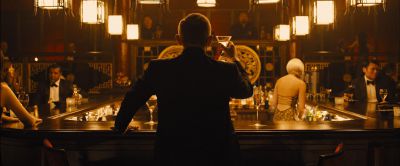 Still from Skyfall (2012) that has been tagged with: medium wide & group-shot & night & restaurant