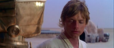 Still from Star Wars: A New Hope (1977) that has been tagged with: medium close-up & clean single & desert