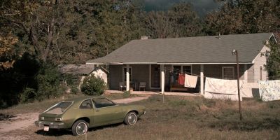 Still from TV Show: Netflix — "Stranger Things: Season 1 - Episode 1" that has been tagged with: car & day & extreme wide & countryside