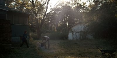 Still from TV Show: Netflix — "Stranger Things: Season 1 - Episode 1" that has been tagged with: day & two-shot & dog & exterior