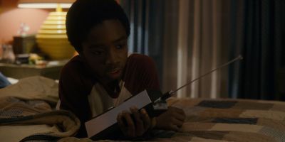 Still from TV Show: Netflix — "Stranger Things: Season 1 - Episode 1" that has been tagged with: b38a6b & night & bed & clean single & bedroom & practical lamp & medium shot