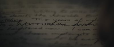 Still from The Batman (2022) that has been tagged with: macro & extreme close-up & handwriting