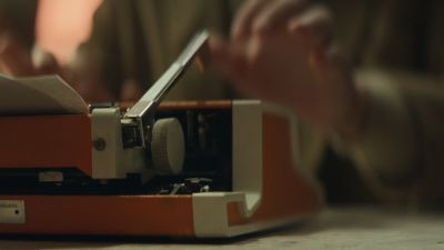 Still from Commercial: SquareSpace — "Storyteller" that has been tagged with: working & table & night & typing & typewriter & insert
