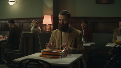 Still from Commercial: SquareSpace — "Storyteller" that has been tagged with: medium shot & clean single & typing & cafe & practical lamp