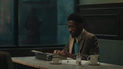 Still from Commercial: SquareSpace — "Storyteller" that has been tagged with: medium shot & clean single & typing & cafe & table