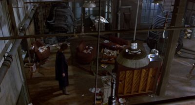 Still from The Fly (1986) that has been tagged with: wide shot & clean single & night & high-angle & interior