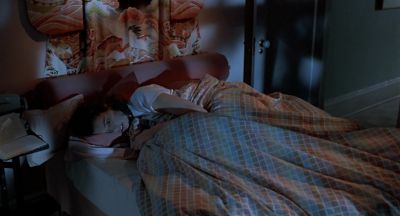 Still from The Fly (1986) that has been tagged with: medium wide & interior & clean single & bed & night