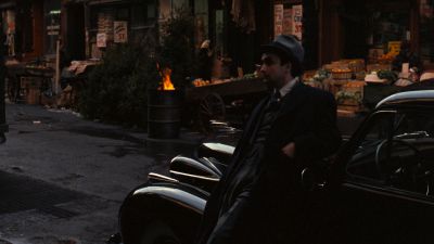 Still from The Godfather (1972) that has been tagged with: grocery store & wide shot & car & exterior