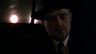 Still from The Godfather (1972) that has been tagged with: car interior & medium shot & hat
