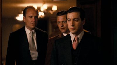 Still from The Godfather (1972) that has been tagged with: medium wide & three-shot & night