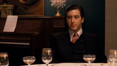 Still from The Godfather (1972) that has been tagged with: medium shot & day & clean single & table