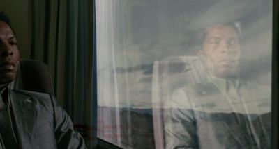 Still from The Limits of Control (2009) that has been tagged with: reflection & train interior