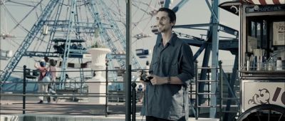 Still from The Machinist (2004) that has been tagged with: day & photographer & camera & amusement park & exterior