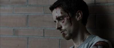 Still from The Machinist (2004) that has been tagged with: interior & brick wall & medium close-up