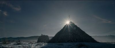 Still from The Revenant (2015) that has been tagged with: lens flare & establishing shot & skull & snow & pyramid