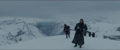 Still from The Revenant (2015) that has been tagged with: gun & mountains & day & group-shot & exterior & wide shot