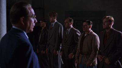 Still from The Shawshank Redemption (1994) that has been tagged with: medium wide & over-the-shoulder & interior & group-shot & day