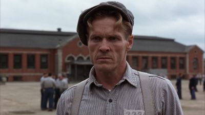 Still from The Shawshank Redemption (1994) that has been tagged with: medium close-up & prison yard & exterior