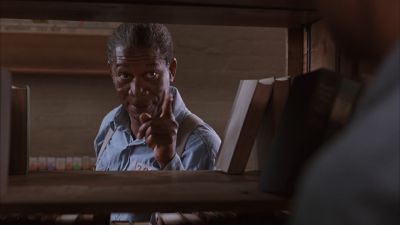 Still from The Shawshank Redemption (1994) that has been tagged with: 4f404c & day & over-the-shoulder & interior & library