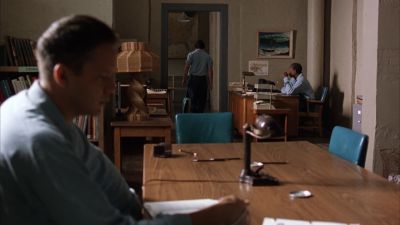 Still from The Shawshank Redemption (1994) that has been tagged with: interior & wide shot & profile shot & three-shot